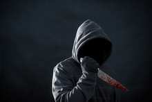 Hooded Man With Bloody Knife In The Dark 
