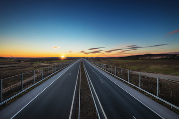 Wall Mural - Aerial view of highway and beautiful sunset, travel around the world