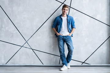 Sticker - Modern and casual. Full length of handsome young man in jeans shirt looking at camera with smile while standing.