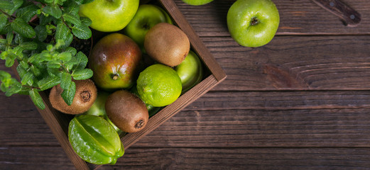 Wall Mural - Set of green fruits for healthy diet and detox: apple, lime, kiwi, mango, carambola and mint.