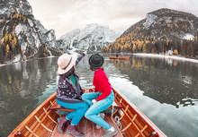 Two Happy Woman Friends On The Boat Or Canoe Cruise Tour On Lago Di Braies Lake In Italian Dolomites Alps