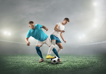 Wall Mural - Caucasian soccer Players in dynamic action with ball in a professional sport game play on the laptop in football under stadium