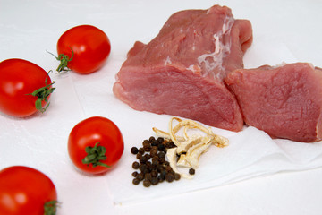 raw fresh meat, red tomatoes , pepper on white background