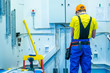 © Grispb - Electrician repairs wiring. Electrical wiring in the cable channel. Construction works. Energy. Installation of electrical wiring. Installation of electricians at the factory. Setup work.