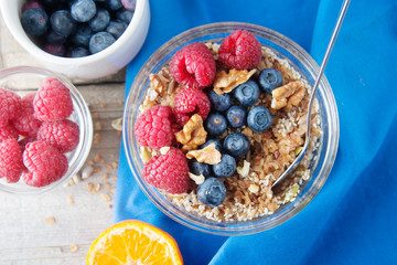 Wall Mural - Cereal, muesli, granola and various delicious fruit, berries for breakfast. healthy, energy breakfast, wooden table.