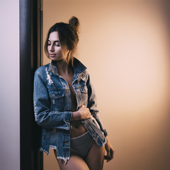 Woman in jeans jacket wearing underwear. shallow depth of field