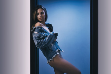 Woman in jeans jacket wearing underwear. shallow depth of field