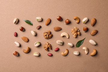 Flat lay composition with organic mixed nuts on color background