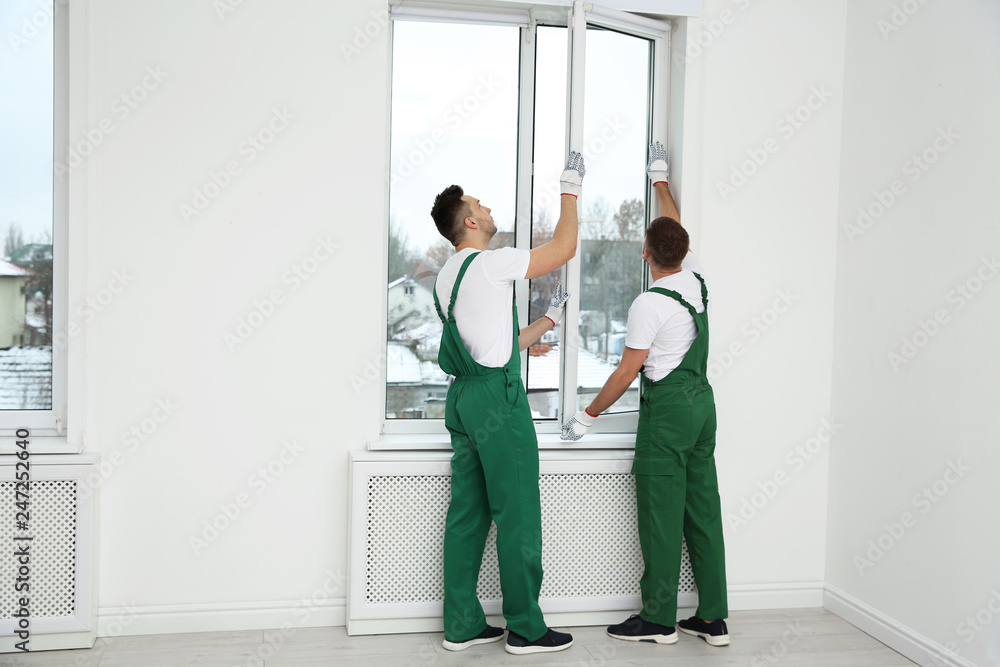 Window Operative Construction Construction workers installing plastic window in house Stock Photo ...