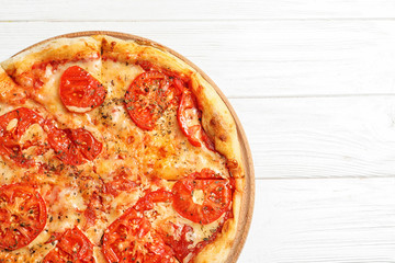 Hot cheese pizza Margherita on white wooden background, top view. Space for text