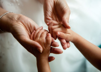 Mother and child, holding hands, hands, tenderness, caring, loving, protection, parenting, children, love, close up, color, horizontal image