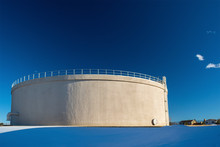 Giant Municipal City Water Tank On A Sunny, Clear Day With Snow