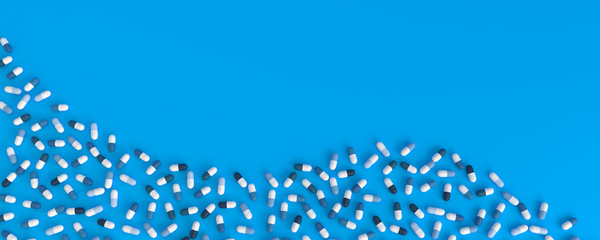 many blue pills poured in the shape of a wave on a blue background, 3d illustration