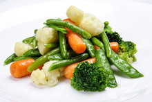 Steamed Vegetables On White Background. Cauliflower, Peas, Broccoli, Carrots And Asparagus Beans.