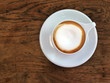 © amKanobi - Cappuccino coffee  in white cup  on the wooden table. Relaxing and fulfill energy. Copy space