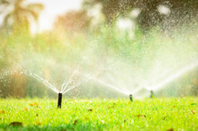 Automatic Lawn Sprinkler Watering Green Grass. Sprinkler With Automatic System. Garden Irrigation System Watering Lawn. Sprinkler System Maintenance Service. Home Service Irrigation Sprinkler.