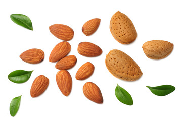 Wall Mural - almonds with green leaves isolated on white background. top view.