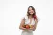 © RussianSaladeStudio - attractive smiling  young woman holding red apples. white background