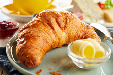 Fresh baked croissant served with butter