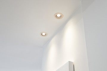 Two spot light illuminated on white ceiling