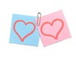 two paper hearts stapled with a paper clip