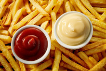 Two Individual Bowls Of Tomato Sauce And Mayo