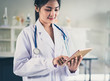 © natara - Doctor using a digital tablet.