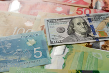 Cash Bills From Canada And USA Currency. Full Frame Of Bills Spread On Table And Assorted Amounts.