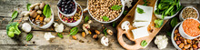 Healthy Plant Vegan Food, Veggie Protein Sources: Tofu, Vegan Milk, Beans, Lentils, Nuts, Soy Milk, Spinach And Seeds. Old Wooden Background Copy Space Banner