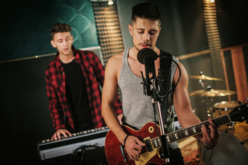 Wall Mural - Music band having rehearsal in a studio