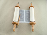 Fototapeta  - The unfolded scroll of the Torah and the pointer lies on the rough canvas.
