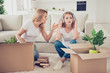 © deagreez - Two nice attractive lovely charming blonde ladies opening boxes with things new life mortgage relocation mad mom bad lazy girl in light white interior room house indoors