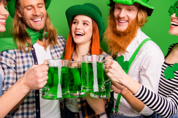 Cropped close-up portrait of attractive cheerful positive glad people guys girls wearing costumes look clinking jar craft ale rest relax in pub having fun isolated over bright vivid shine background