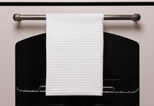 White Kitchen Towel Hangs On The Oven Handle, Product Mockup