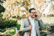 © bnenin - Portrait of a successful businessman talking on smart phone outdoors.