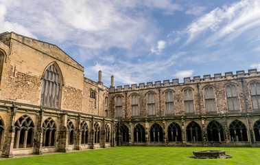 courtyard of a medieval cathedral, with a tower and walls.  