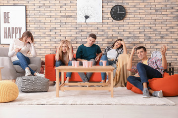 Canvas Print - Emotional young people watching movie in home cinema