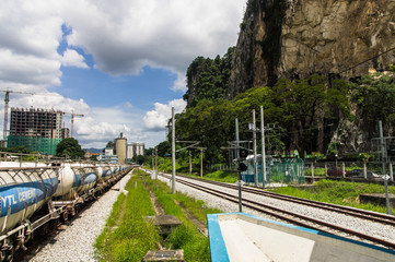 Cisterns of a freight train on the railroad tracks along the steep cliffs. Batu caves station. malaysia