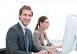 © ASDF - close up.smiling businessman with an assistant at the Desk