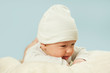 ©  Даниил Дудник - emotional newborn beautiful tender baby lies on a white blanket. The concept of health