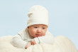 ©  Даниил Дудник - emotional newborn beautiful tender baby lies on a white blanket. The concept of health