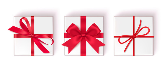 Wall Mural - set of decorative white gift boxes with red bow and ribbon isolated on white background. top view. v