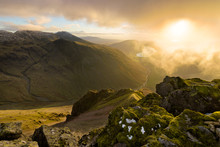 Dramatic Sunlight Breaking Through Clouds From The Summit Of Great Gable In The English Lake District.