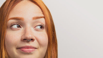 Wall Mural - portrait of a pretty redhead girl looking at side