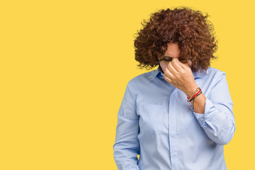 Beautiful middle ager senior businees woman wearing glasses over isolated background tired rubbing nose and eyes feeling fatigue and headache. Stress and frustration concept.