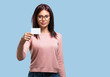 © Asier - Young pretty woman smiling confident, offering a business card, has a thriving business, copy space to write whatever you want