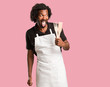 © Asier - Handsome african american baker expression of confidence and emotion, fun and friendly, showing tongue as a sign of play or fun
