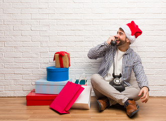 Young crazy man celebrating christmas in his house