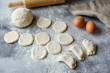 © chernikovatv - Preparation dough and production of circles from dough for preparation of dumplings with a stuffing. It can be used as a background