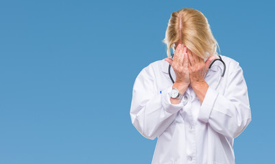 Sticker - Middle age blonde doctor woman over isolated background with sad expression covering face with hands while crying. Depression concept.